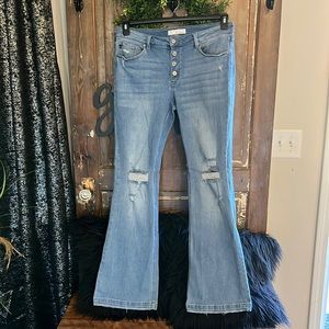 KanCan distressed slightly flared light wash jeans.